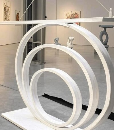 The Modern Concentric Ring Sculpture with Figurines is a bold, hangable art piece featuring suspended concentric rings and minimal figurines